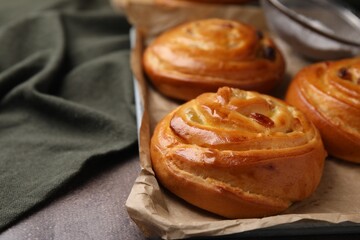 Sweet buns. Delicious rolls on brown textured table, closeup. Space for text