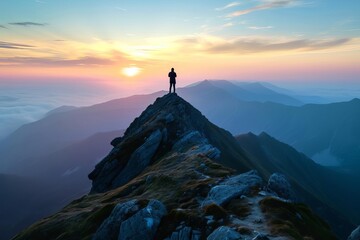 Person standing on a mountain peak during sunset A symbol of achievement and the beauty of nature