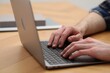© New Africa - E-learning. Man using laptop during online lesson at table indoors, closeup