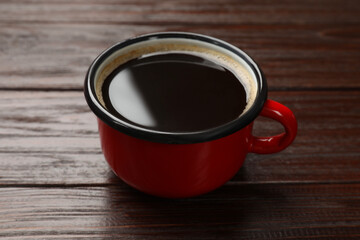 Poster - Cup of aromatic coffee on wooden table, closeup