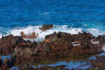 Wall Mural - Ocean waves breaking on the rocks on the island 