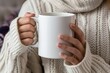© InfiniteStudio - Hands in sweater holding mug.
