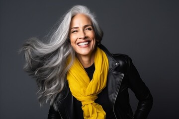 Wall Mural - Portrait of a happy mature woman with long grey hair and black leather jacket