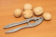 Walnuts, shell tongs on the table.