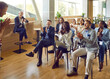© Studio Romantic - Happy audience applauding coach after training session at business conference. Diverse male and female businesspeople and entrepreneurs give speaker ovation after his talk on motivation and leadership