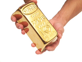 Hand holding a gold bar isolated