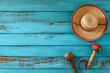 Colorful Mexican Culture Still Life - Straw Sombrero and Traditional Maracas on Rustic Blue Wooden Background