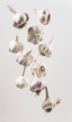 Wall Mural - slice of garlic float in the air in white background.