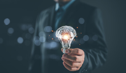 Fototapete - Businessman holding illuminated lightbulb, idea, innovation and inspiration with glowing virtual brain, smart intelligent creativity with bulbs, Motivation and innovation concept
