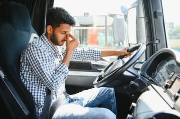 exhausted truck driver falling asleep on steering wheel. tiredness and sleeping concept