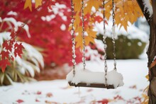 Snowfilled Tree Swing With A Backdrop Of Red And Gold Leaves