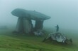 jogger pausing near a dolmen in fog