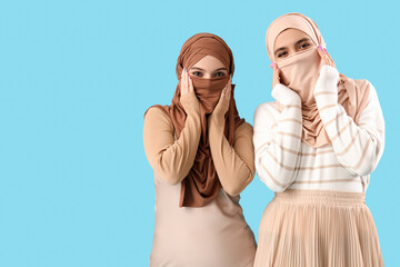 Sticker - Young Muslim women in hijab on blue background