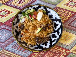 Wall Mural - Uzbek pilaf on a plate on the table