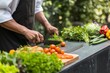 chef chopping vegetables on an outdoor counter