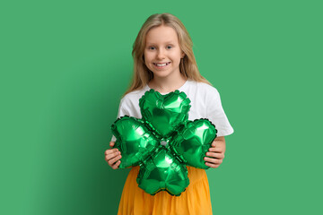 Wall Mural - Cute little girl with air balloon in shape of clover on green background. St. Patrick's Day celebration