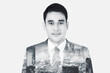 © Creativa Images - The double exposure image of the Asian business man standing overlay with cityscape image
