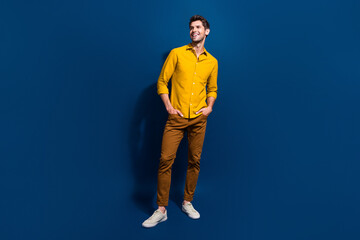 Canvas Print - Full body photo of handsome young guy hands pockets look empty space wear trendy yellow outfit isolated on dark blue color background