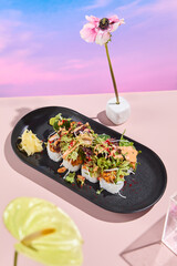 Wall Mural - Salmon roll sushi with a mix of salad on top, elegantly presented on a black plate with surreal floral spring and summer theme