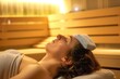 person lying on back in sauna, cold compress over forehead, relaxing