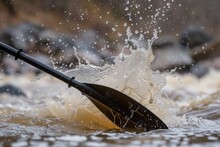 Kayakers Oar Striking Water, Splashing Upwards