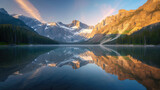 Fototapeta Góry - Reflection of dawn on a calm lake with the majesty of misty mountains