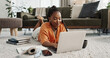 © Coetzee/peopleimages.com - Laptop, education and a student black woman on the floor of a living room to study for a test or exam. Computer, smile and a happy young person learning with an online course for upskill development