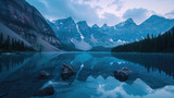 Fototapeta Góry - Reflection of majestic mountains on a calm lake in the morning under a blue sky