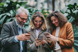 © Patcharaphon - Group of business people using a mobile phone while talking together. Business, lifestyle concept