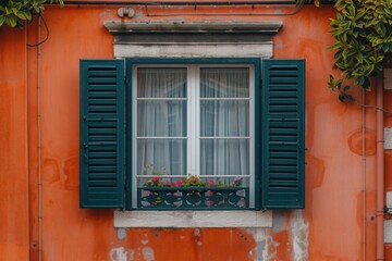 Poster - A window with green shutters on an orange building. Suitable for architectural or travel-related projects