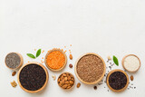 Fototapeta Mapy - Various superfoods in smal bowl on colored background. Superfood as rice, chia, quinoa, lentils, nuts, sesame seeds, almonds. top view copy space