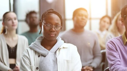 Wall Mural - Successful African American manager sitting in front of her colleagues