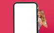 Leinwandbild Motiv Blonde Woman Showing Large Phone Pointing At Blank Screen, Studio