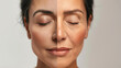 © MP Studio - close-up of a woman's face showing a comparison between youthful skin on one side and aged skin with wrinkles on the other, against a neutral background