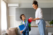 © Prostock-studio - Black mother prepares son with backpack and notebooks for school