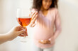 No alcohol during pregnancy. Black pregnant woman refusing to drink offered wine