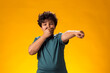 Kid boy laughing at somebody and pointing finger at camera. Bulling concept