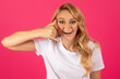 Leinwandbild Motiv Cheerful millennial blonde lady gesturing Call Me on pink background