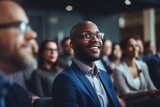 Fototapeta  - Portrait happy smiling African American ethnic male man guy businessman student in glasses formal suit listening business training class seminar presentation learning blurred crowd indoor meeting room