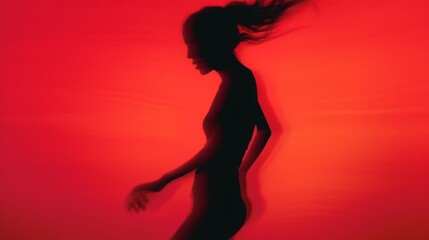 Wall Mural - Female blurred silhouette on a red background. Elegant outline of a woman in motion out of focus