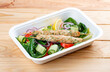 Chicken lula kebab with herbs and vegetables. Healthy food. Takeaway food. On a wooden background.