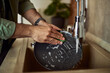 © Jelena - A male's hands washing a plate in the kitchen sink using a sponge and a detergent.