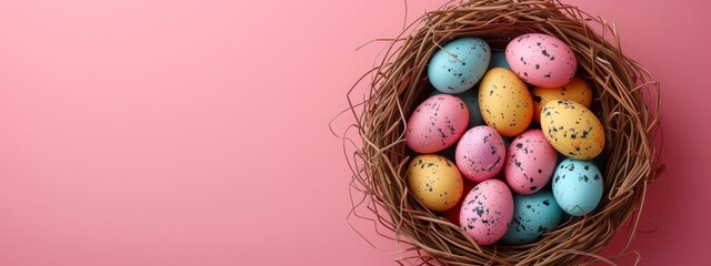 Canvas Print - colorful easter eggs in a nest on pastel pink background, banner with copyspace, top view