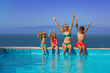 © Sergey Novikov - Mother and three children have fun, scream, sit on edge of pool