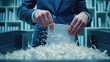 © lensofcolors - Executive hands in a suit destroying confidential documents with financial information. Destruction and protection of economic, personal and business data.