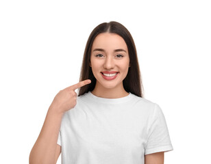 Poster - Young woman pointing at her clean teeth and smiling on white background