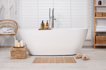 Wall Mural - Stylish bathroom interior with bamboo bath mat and white tub