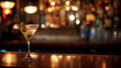 Cocktail sitting on bar counter in a well-stocked bar, shallow depth of field