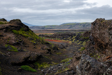 Amazing Icelandic landscape with mountains and field on a cloudy day at famous Laugavegur hiking trail, South Iceland. Acid colours landscape.