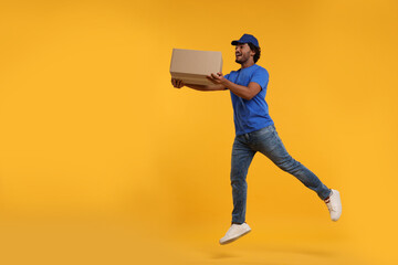 Canvas Print - Happy courier running to deliver parcel on orange background, space for text